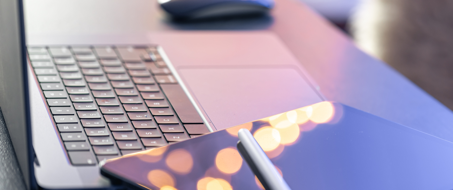 Digital tablet, stylus pen and laptop on the desktop, close up.